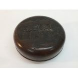 A 20th Century Chinese carved hardwood circular shaped box and cover, signed base.