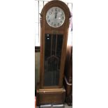 An Art Deco oak longcase clock with weights and pendulum