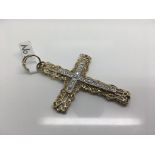 A 9ct gold stone set cross. Weight approx 11.33g