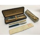 A collection of pens and propelling pencils by various makers including Waterman and Parker.