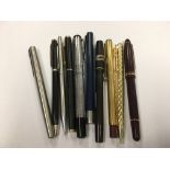 A collection of pens including Parker, Mont Blanc