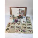 A collection of WW1 silk postcards, a stamp album