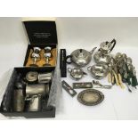 A collection of metalware including a pewter four piece tea and coffee service, various cutlery,