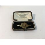 An Australian commonwealth forces brooch in 9ct go