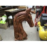 A modern wood sculpture of a horses head. Height a