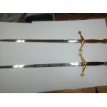 Two modern swords with mahogany grips, one bearing