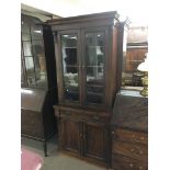 A two door glazed mahogany bookcase fitted with a