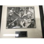 A framed black and white photograph signed Norman