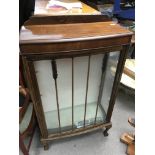 A mahogany glass bronzed display cabinet with ball