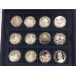 A cased set of twenty four silver coins.