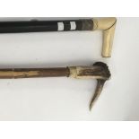 A walking stick with ivory handle and silver colla