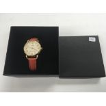 A boxed coach ladies watch.