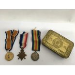A 1914 Christmas tin containing three medals award