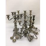 A box of silver plated candelabra and brass candle