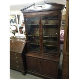 An astral glazed two door mahogany bookcase, appro