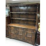 A large reproduction mahogany dresser with scroll