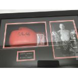 A framed boxing glove signed by sir Henry cooper w