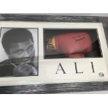 A framed Muhammad Ali signed glove and photo with