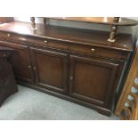 A reproduction mahogany sideboard fitted with thre