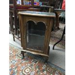 A small display cabinet with glass shelf.