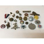 A collection of badges including a WW2 German Nati