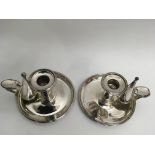 A pair of silver plated chambersticks, the thumb r