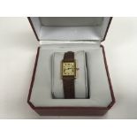 A boxed ladies Cartier tank watch.