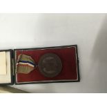 A boxed 1900 school competition medal presented by