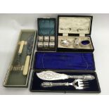 A cased silver plated condiment set, a set of napk