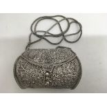 A silver bag with floral relief decoration, stampe