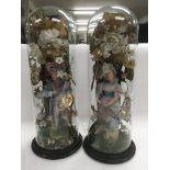 A pair of spelter figures unde glass domes. Height