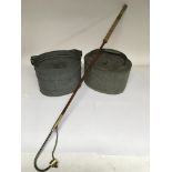 A vintage fishing gaff and two galvanised metal li