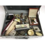 A brief case containing mixed costume jewellery an