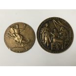 Two circular bronze medals.