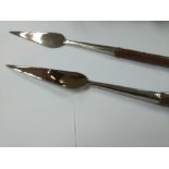 A pair of short spade end spears with wooden grips