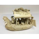 An ivory junk with carved figurehead of a chicken.