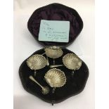 A cased set of four silver plated shell salts in o