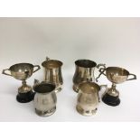 A collection of four silver plated sporting tankar