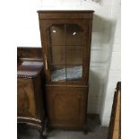 A walnut display cabinet with single glazed door a