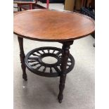 An Edwardian mahogany revolving top table, with ci