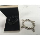 A boxed links of London bracelet with 4 charms.