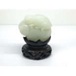 A small carved, light green jade model of a grassh