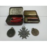 Three German WW2 medals with ribbons.