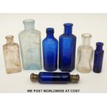 Seven glass bottles including a white metal mounted double ended scent bottle, 10cm long.