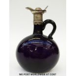 A white metal mounted amethyst glass ewer with applied handle,