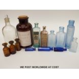 A collection of glass pharmaceutical jars and bottles, many with original paper labels.