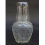A clear glass decanter and up with engraved decoration, 17cm tall.