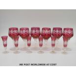 A set of six flash overlaid cut cranberry wine glasses (16cm tall) together with a similar set of