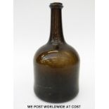 A late 18th century mallet shaped olive green/ brown glass bottle with deep base, 22cm tall.