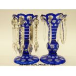 A pair of flash overlaid blue glass lustres with clear cut drops, 17cm tall.